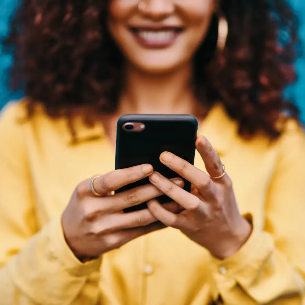 Woman smiling and looking at her phone