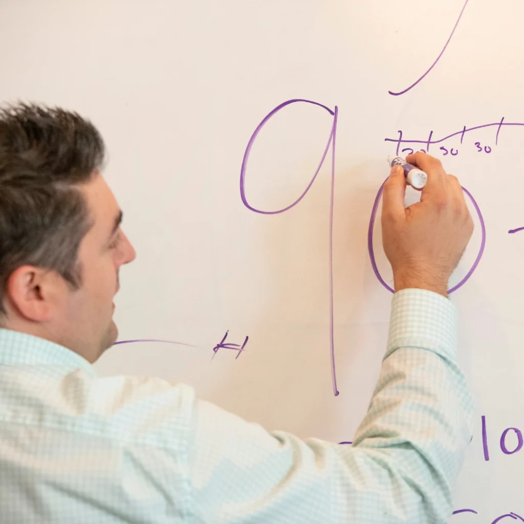 Gavin Baker of Baker Marketing Laboratory writing on a whiteboard